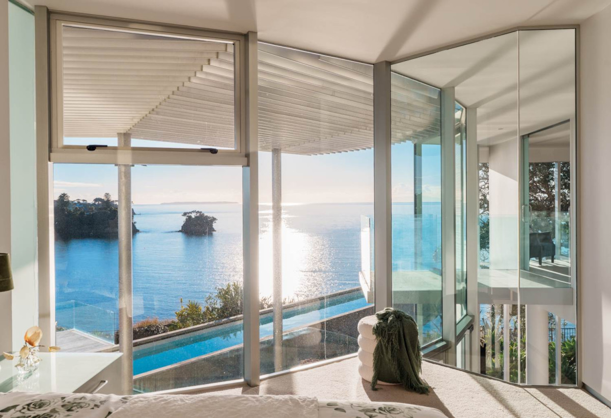 Just 160 metres from Waiake Beach, 1948m2 section, Built-in lift, 5 beds (5 ensuites) + office and wine room 6.5 baths house with 4 garage and the 18-metre cantilevered lap pool, 4 Sharon Road, Waiake, Auckland