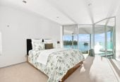 Just 160 metres from Waiake Beach, 1948m2 section, Built-in lift, 5 beds (5 ensuites) + office and wine room 6.5 baths house with 4 garage and the 18-metre cantilevered lap pool, 4 Sharon Road, Waiake, Auckland