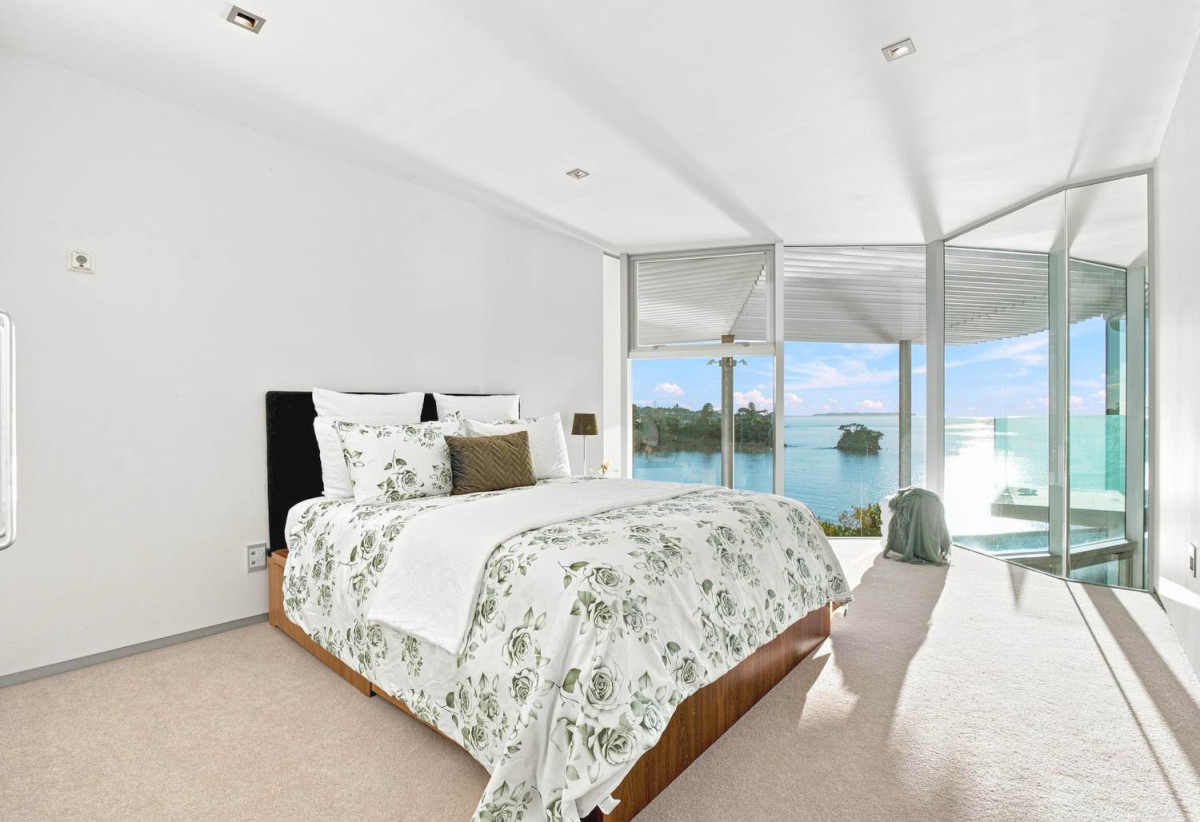 Just 160 metres from Waiake Beach, 1948m2 section, Built-in lift, 5 beds (5 ensuites) + office and wine room 6.5 baths house with 4 garage and the 18-metre cantilevered lap pool, 4 Sharon Road, Waiake, Auckland