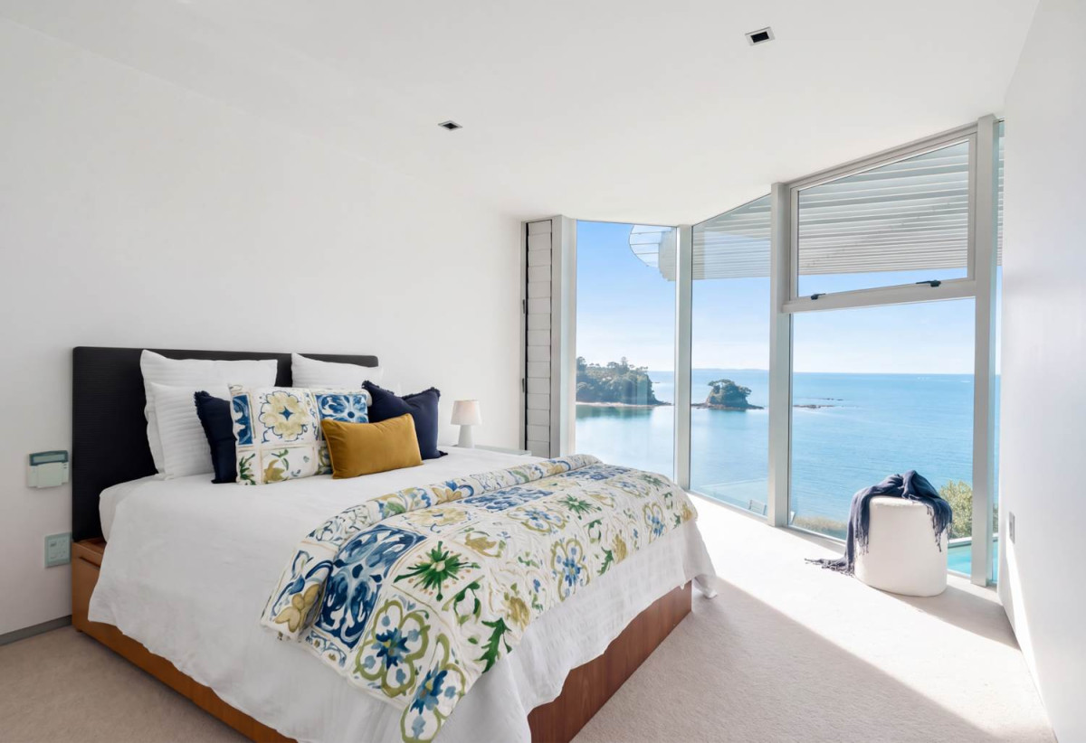 Just 160 metres from Waiake Beach, 1948m2 section, Built-in lift, 5 beds (5 ensuites) + office and wine room 6.5 baths house with 4 garage and the 18-metre cantilevered lap pool, 4 Sharon Road, Waiake, Auckland