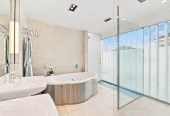 Just 160 metres from Waiake Beach, 1948m2 section, Built-in lift, 5 beds (5 ensuites) + office and wine room 6.5 baths house with 4 garage and the 18-metre cantilevered lap pool, 4 Sharon Road, Waiake, Auckland