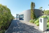 Just 160 metres from Waiake Beach, 1948m2 section, Built-in lift, 5 beds (5 ensuites) + office and wine room 6.5 baths house with 4 garage and the 18-metre cantilevered lap pool, 4 Sharon Road, Waiake, Auckland