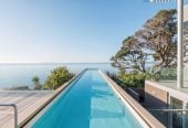 Just 160 metres from Waiake Beach, 1948m2 section, Built-in lift, 5 beds (5 ensuites) + office and wine room 6.5 baths house with 4 garage and the 18-metre cantilevered lap pool, 4 Sharon Road, Waiake, Auckland