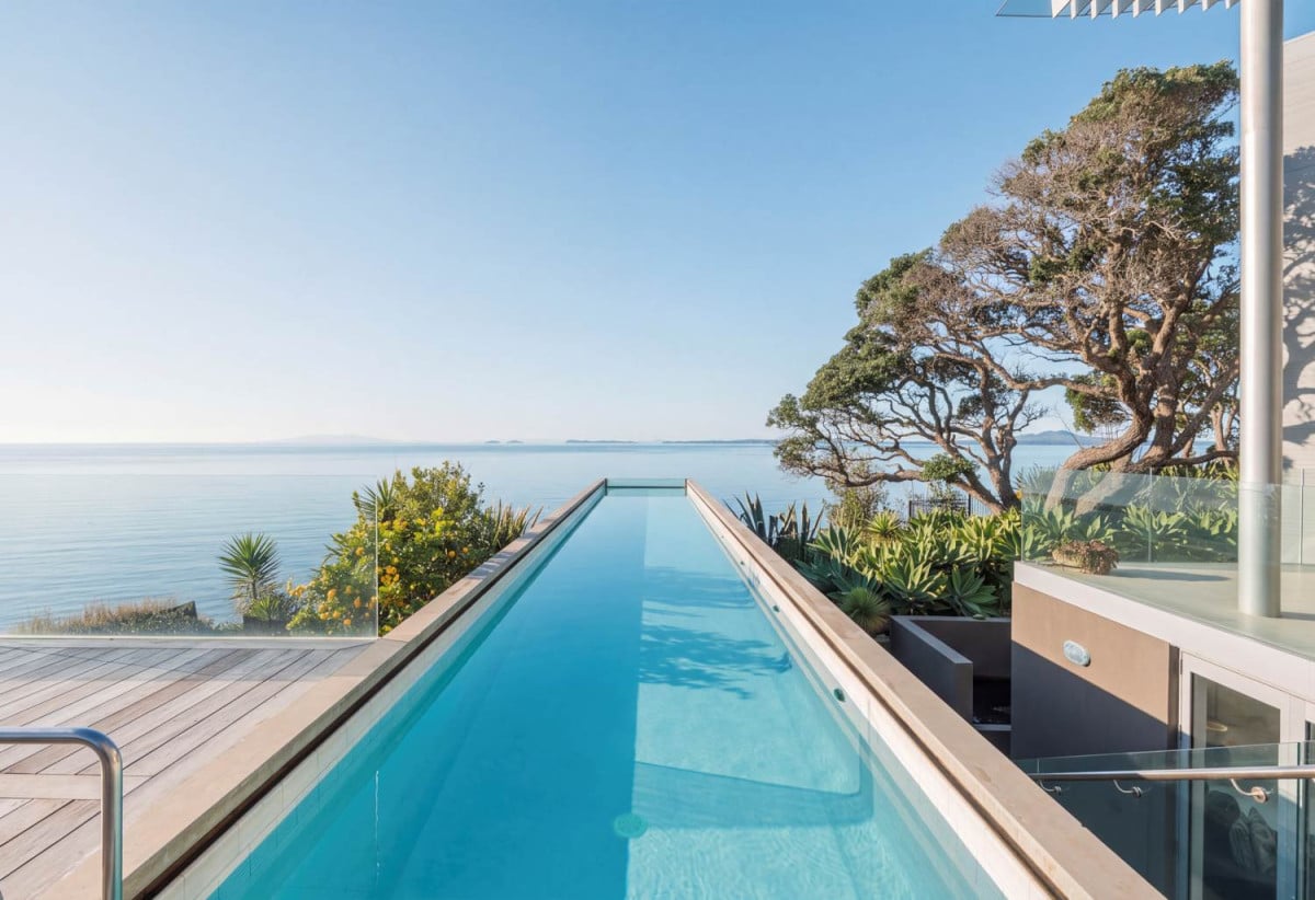 Just 160 metres from Waiake Beach, 1948m2 section, Built-in lift, 5 beds (5 ensuites) + office and wine room 6.5 baths house with 4 garage and the 18-metre cantilevered lap pool, 4 Sharon Road, Waiake, Auckland
