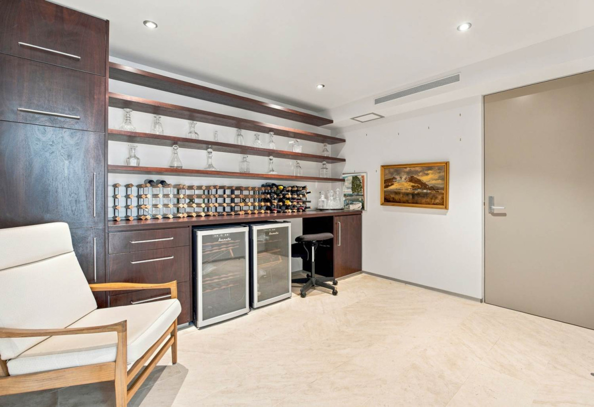 Just 160 metres from Waiake Beach, 1948m2 section, Built-in lift, 5 beds (5 ensuites) + office and wine room 6.5 baths house with 4 garage and the 18-metre cantilevered lap pool, 4 Sharon Road, Waiake, Auckland