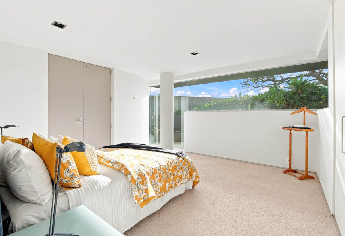 Just 160 metres from Waiake Beach, 1948m2 section, Built-in lift, 5 beds (5 ensuites) + office and wine room 6.5 baths house with 4 garage and the 18-metre cantilevered lap pool, 4 Sharon Road, Waiake, Auckland
