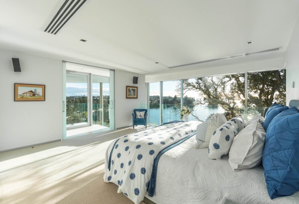 Just 160 metres from Waiake Beach, 1948m2 section, Built-in lift, 5 beds (5 ensuites) + office and wine room 6.5 baths house with 4 garage and the 18-metre cantilevered lap pool, 4 Sharon Road, Waiake, Auckland