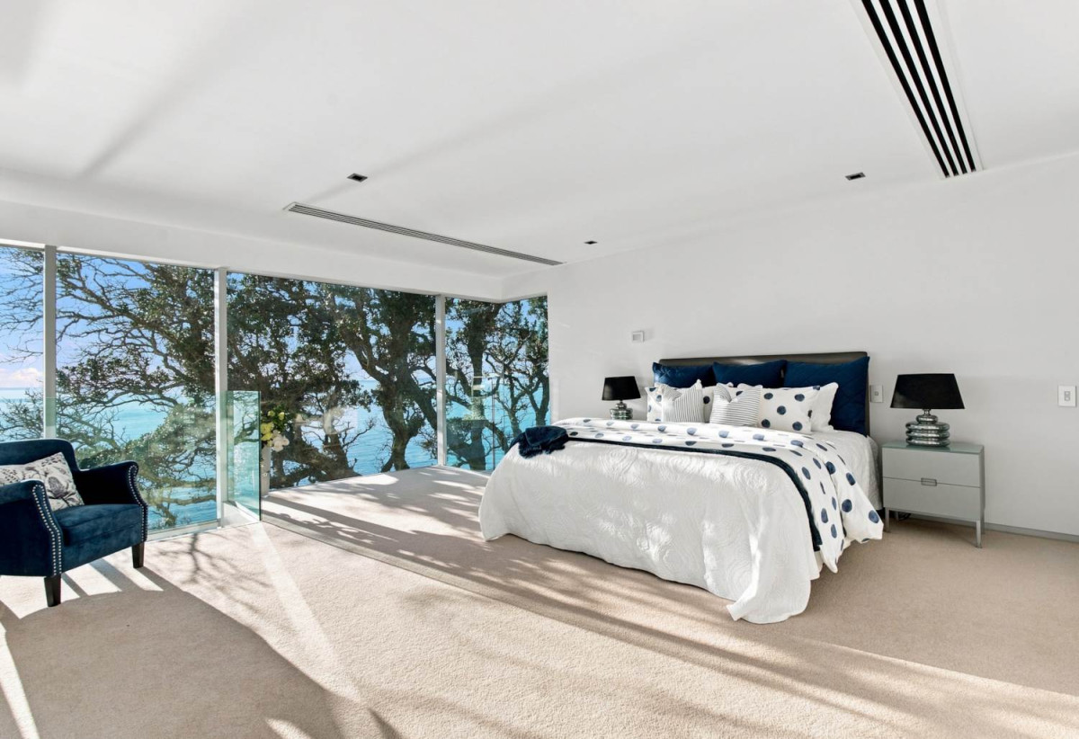 Just 160 metres from Waiake Beach, 1948m2 section, Built-in lift, 5 beds (5 ensuites) + office and wine room 6.5 baths house with 4 garage and the 18-metre cantilevered lap pool, 4 Sharon Road, Waiake, Auckland