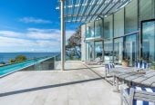 Just 160 metres from Waiake Beach, 1948m2 section, Built-in lift, 5 beds (5 ensuites) + office and wine room 6.5 baths house with 4 garage and the 18-metre cantilevered lap pool, 4 Sharon Road, Waiake, Auckland